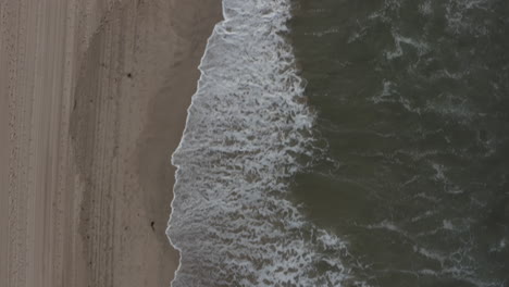 AERIAL:-Birdsview-on-waves,water-on-Beach-in-Venice,-Los-Angeles,-California